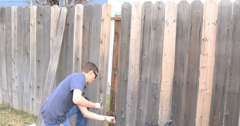 Fence gate repair with new hinges, latch hardware, and level alignment