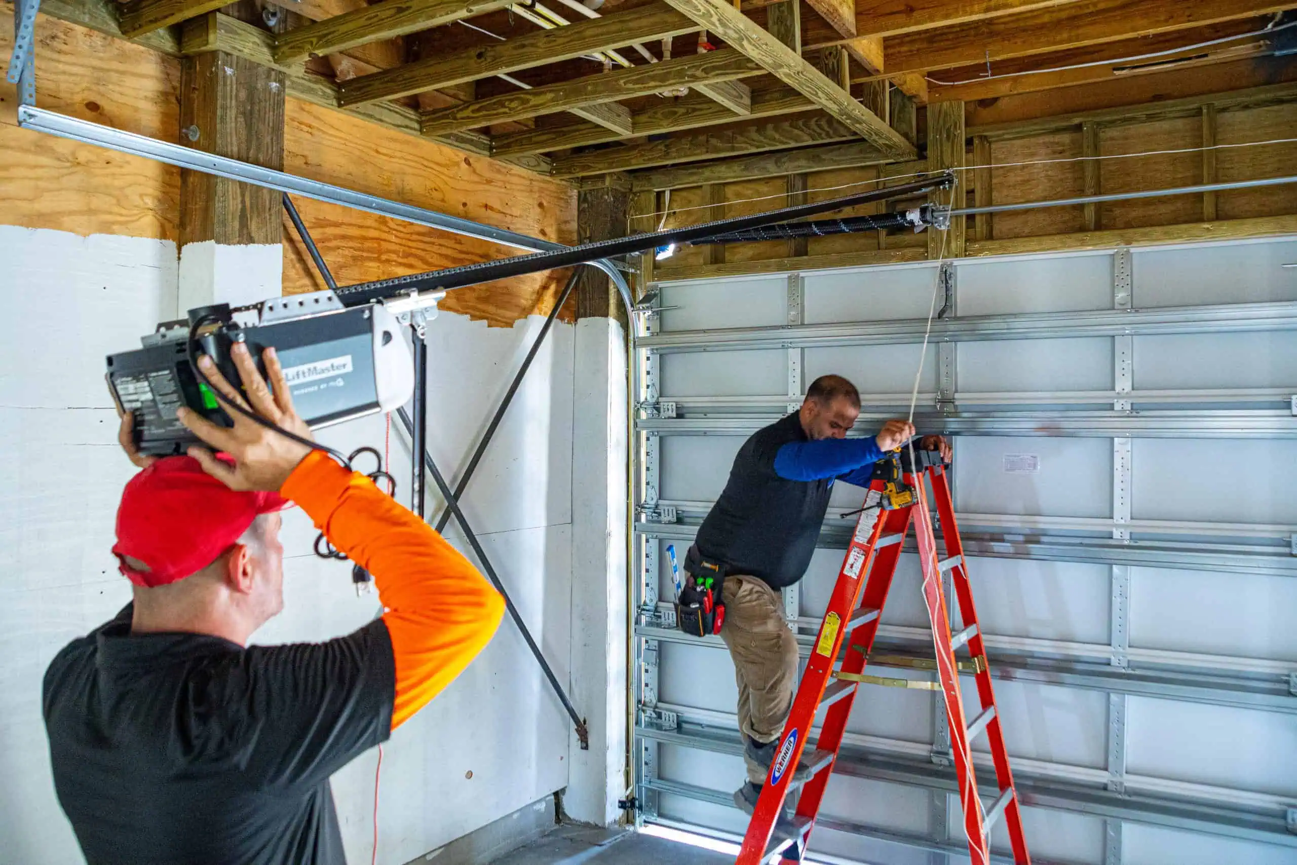 New garage door installation with insulated steel panel and modern hardware